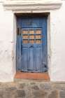 Casares, Malaga, Andalusia, Spain. A weather blue door on a white stucco house. Art Print
